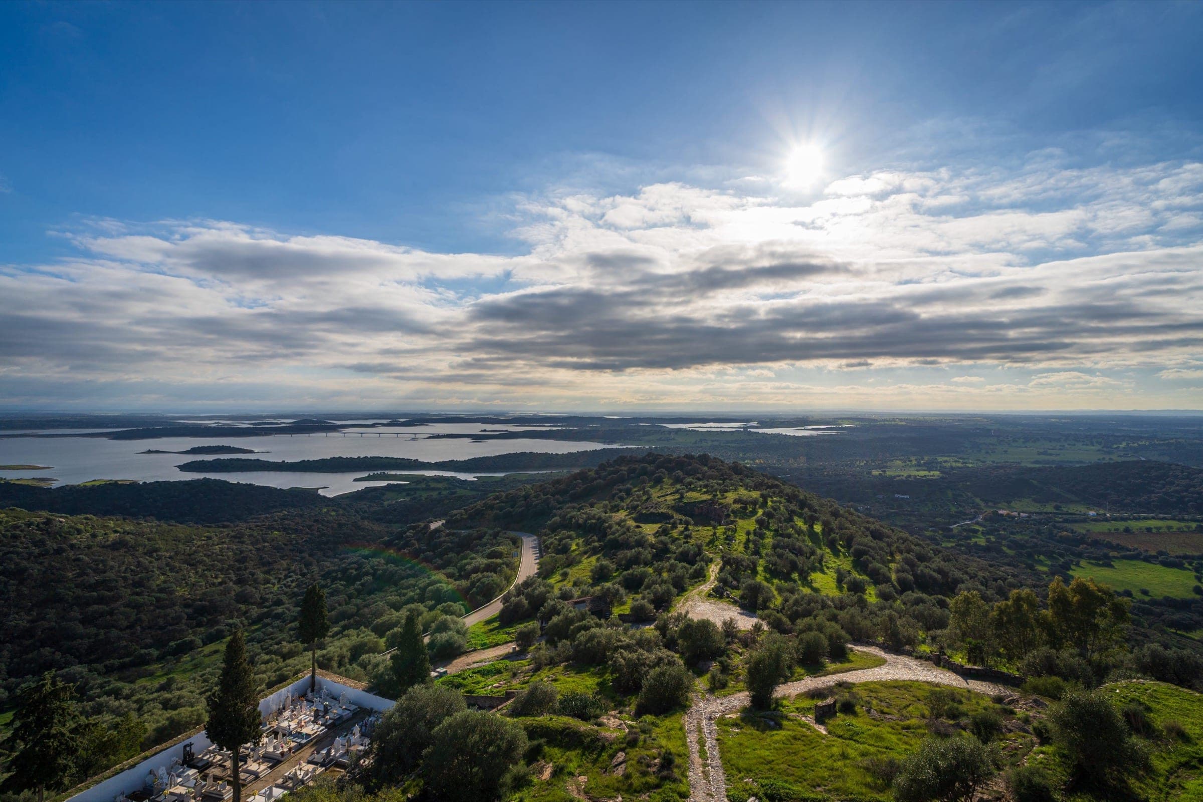 An aerial view of Lake Alqueva, its arms of water reaching into valleys covered in holm oak.