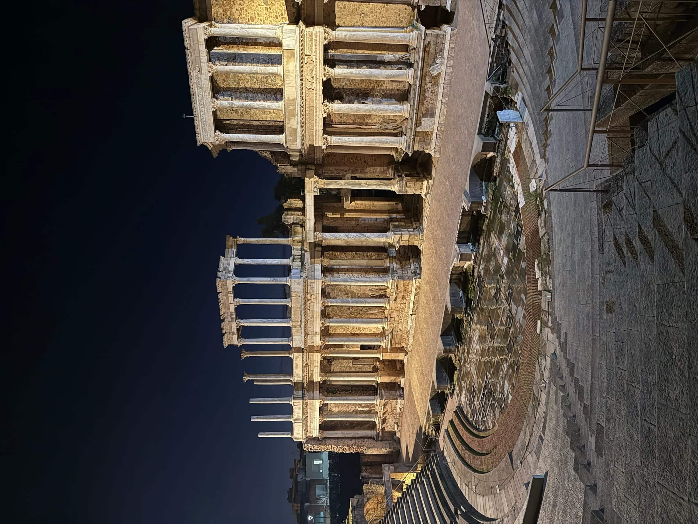 The Roman theatre of Mérida lit up, its two tiers of columns on the stage front.